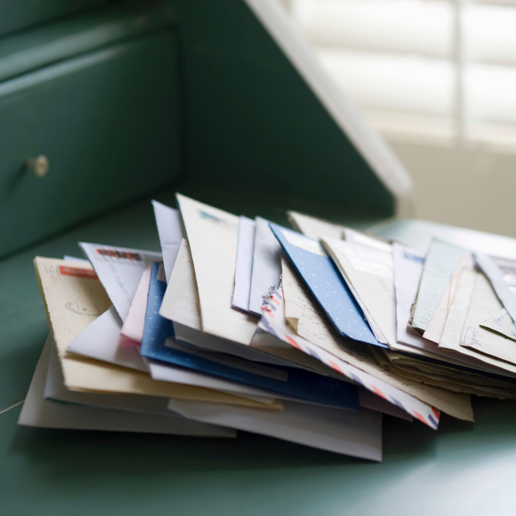 Stack of Mail on a Green Desk