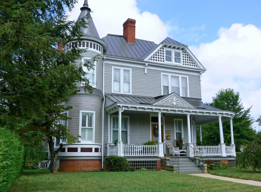 a beautiful old victorian mansion on a big lot and a nice porch.
