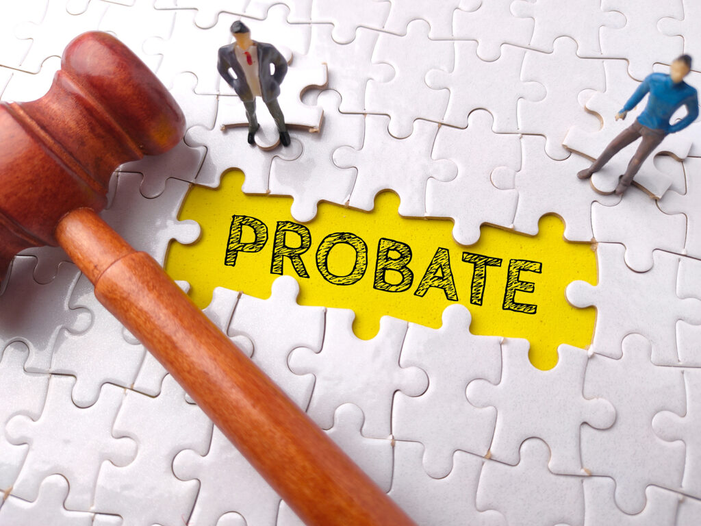 Top view miniature people and gavel with text PROBATE on puzzle background.