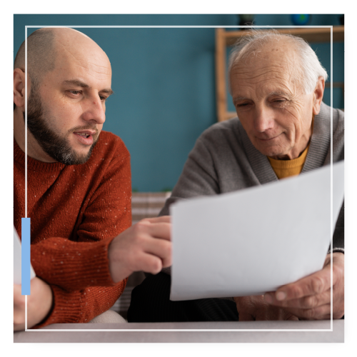 Father and son reviewing paperwork together