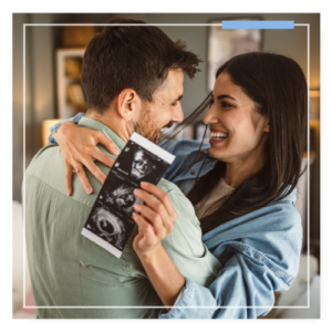 Updating An Estate Plan - Couple hugging with excitement over them being pregnant. She is holding the ultrasound in her hand.