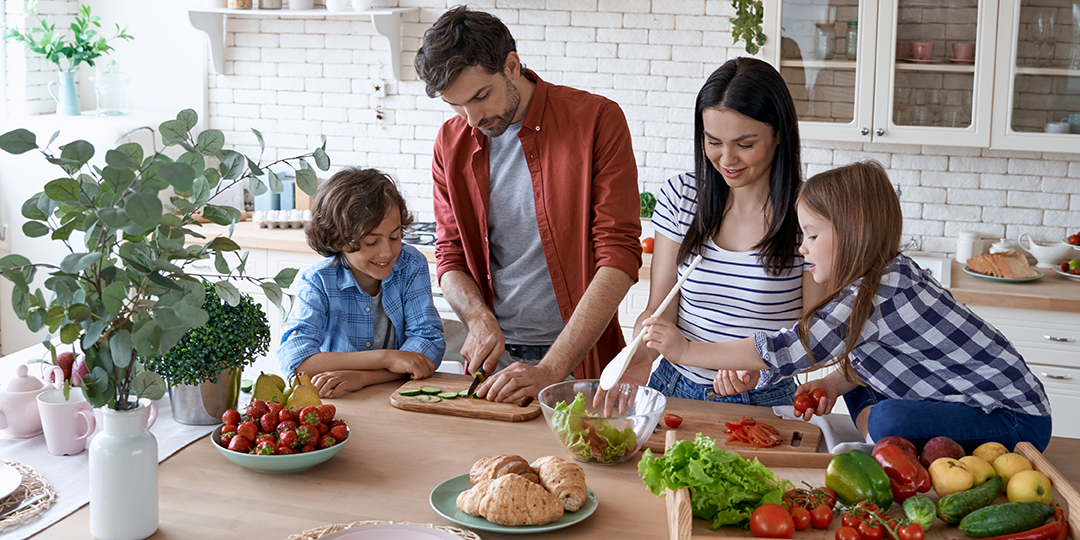 Family in the kitchen preparing a meal together - symbolizes the ease of estate planning via zoom